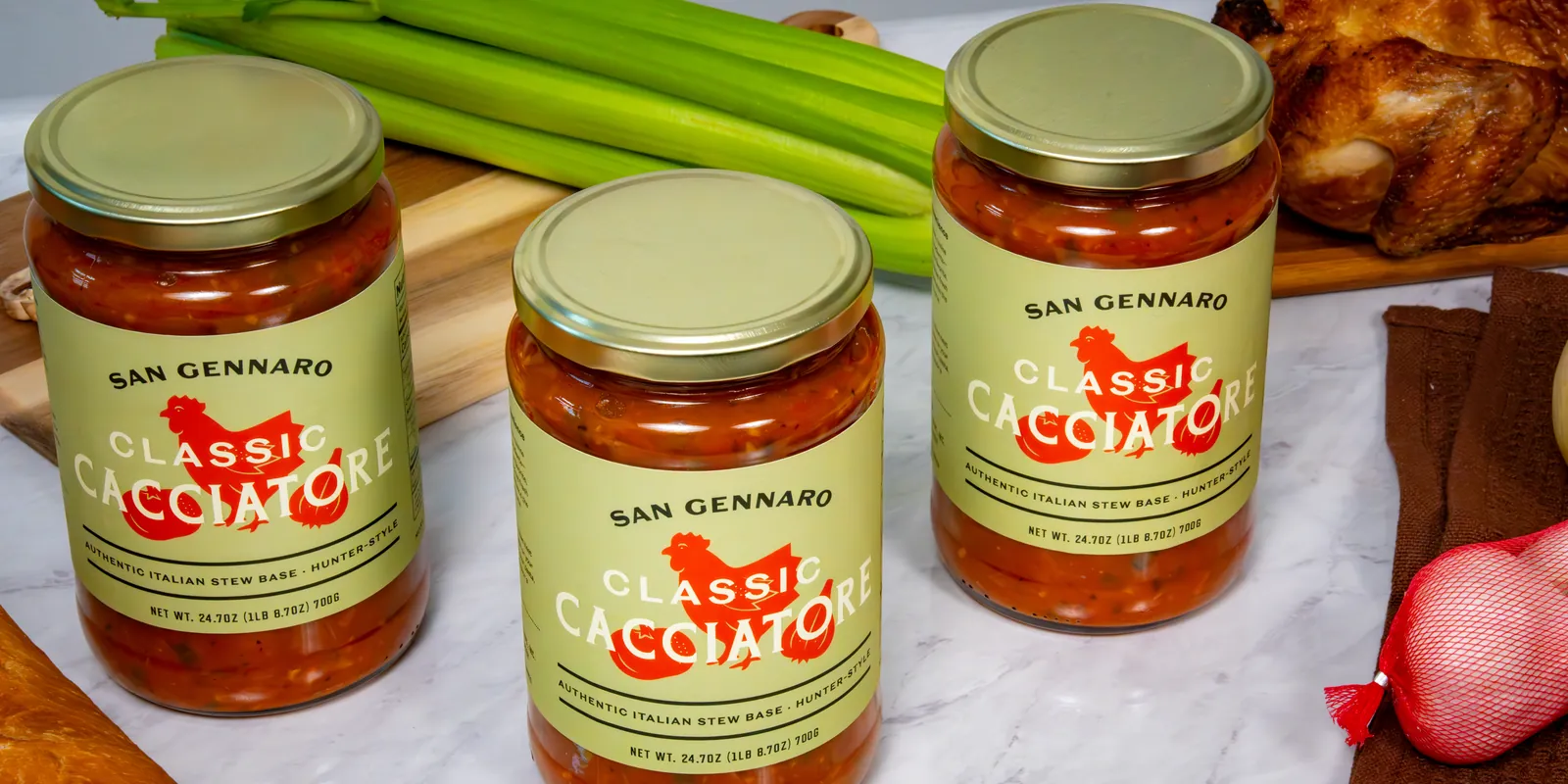 Three jars of San Gennaro Classic Cacciatore stew base on a marble counter.
